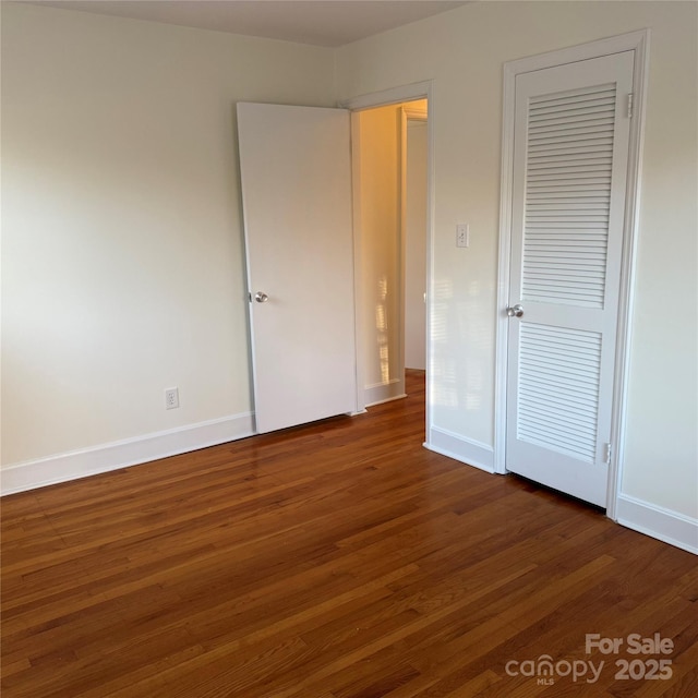 unfurnished bedroom featuring dark hardwood / wood-style floors