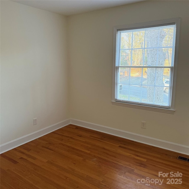 spare room with hardwood / wood-style floors