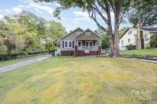 view of front facade featuring a front lawn and covered porch