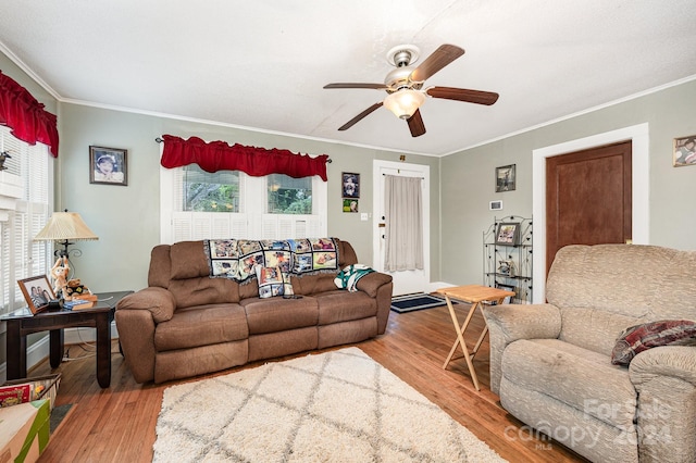 living room featuring ornamental molding, a wealth of natural light, ceiling fan, and hardwood / wood-style flooring