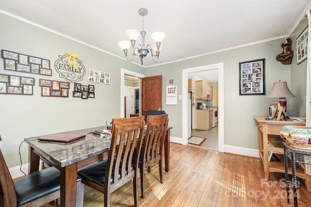 dining space with a chandelier, light hardwood / wood-style floors, and crown molding