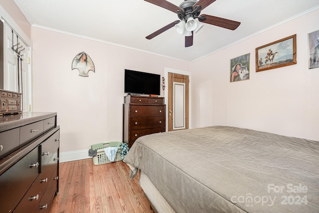 bedroom featuring ceiling fan, light wood-type flooring, and ornamental molding