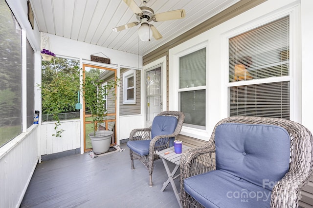 sunroom / solarium featuring wooden ceiling and ceiling fan