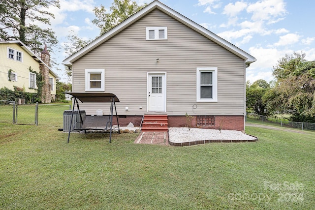 rear view of property featuring a lawn and a patio area