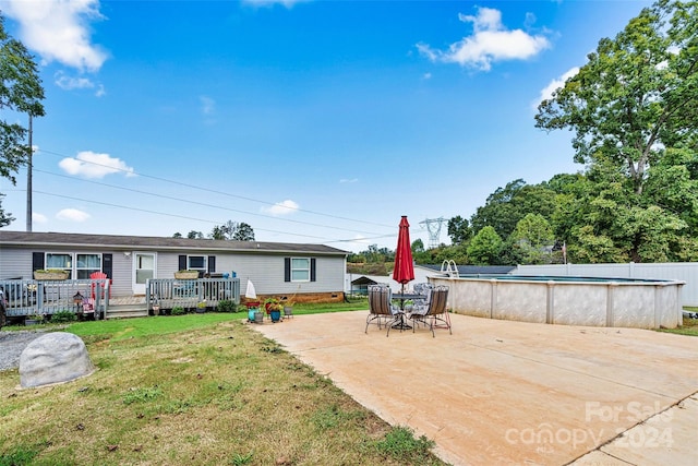 7686 Hickory Creek Dr, Denver, NC 28037 - rear view of property with fence, a deck, an outdoor pool, crawl space, and a lawn