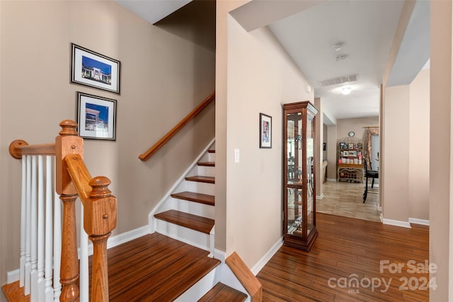 stairway featuring wood-type flooring