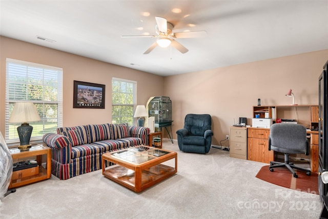 interior space with ceiling fan and light colored carpet