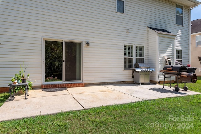 back of property featuring a lawn and a patio area