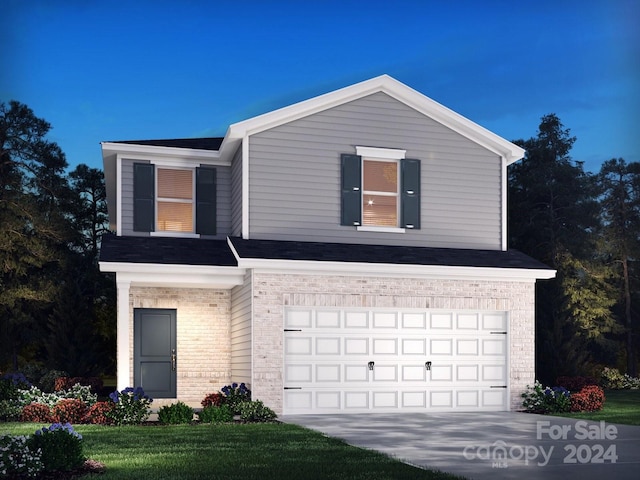 view of front of property with a front yard and a garage