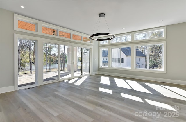 unfurnished sunroom featuring a healthy amount of sunlight