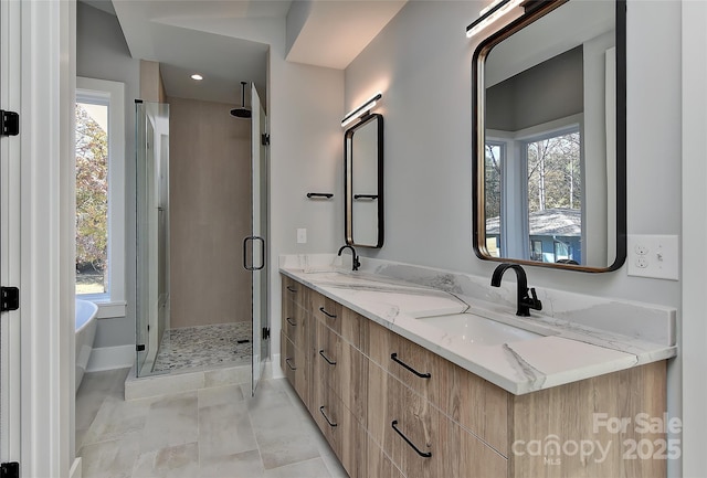 bathroom featuring vanity and shower with separate bathtub