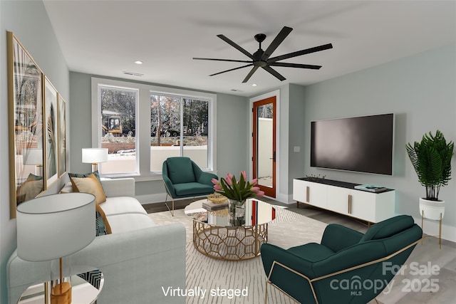 living room with ceiling fan and hardwood / wood-style flooring