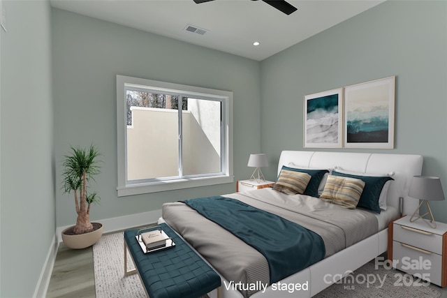 bedroom with ceiling fan and light hardwood / wood-style floors