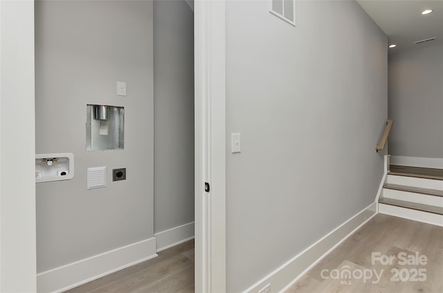 laundry room with washer hookup, light hardwood / wood-style flooring, and hookup for an electric dryer