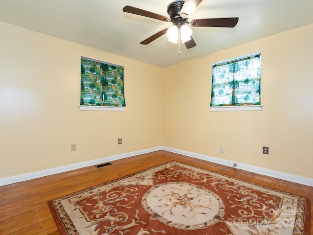 unfurnished room with ceiling fan and wood-type flooring