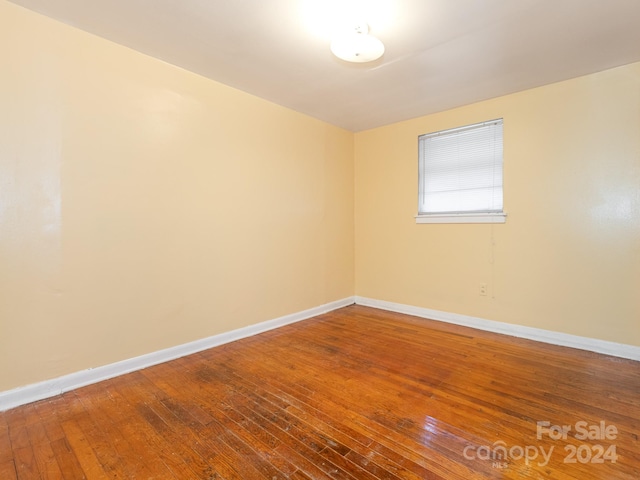 empty room with hardwood / wood-style flooring