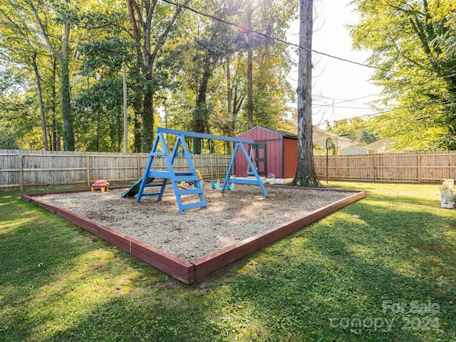 view of playground with a storage unit and a yard