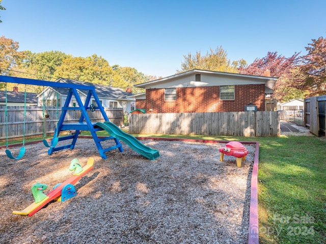 view of jungle gym with a lawn