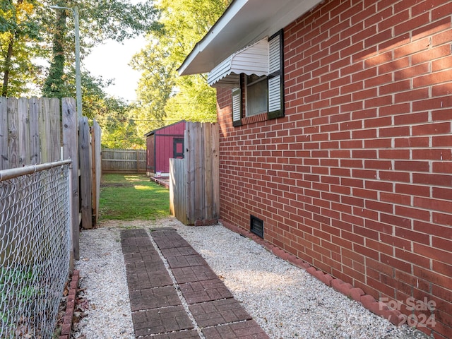 view of side of home featuring a storage unit