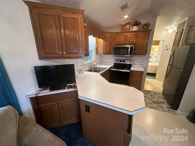 kitchen with a textured ceiling, sink, lofted ceiling, stainless steel appliances, and backsplash