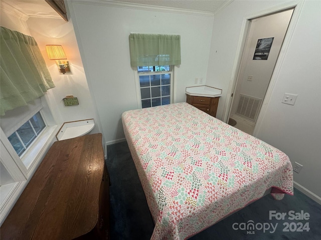 bedroom with carpet flooring and ornamental molding