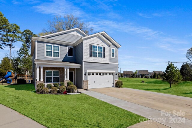 view of front facade with a garage and a front lawn