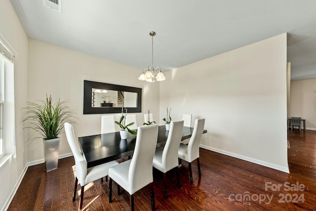 dining area featuring an inviting chandelier and dark hardwood / wood-style flooring