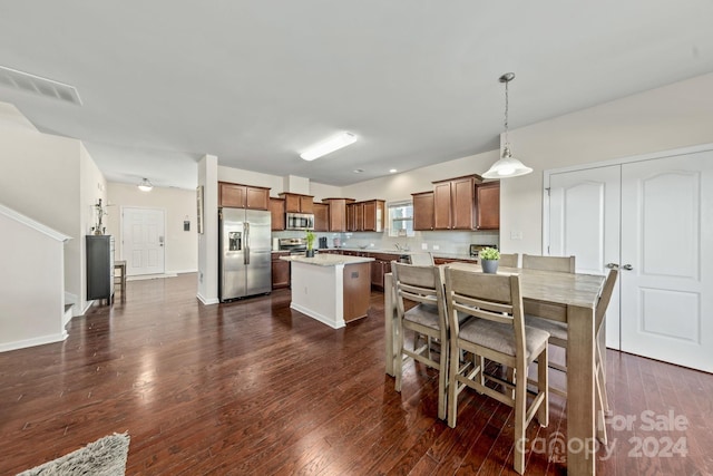 dining space with dark hardwood / wood-style floors