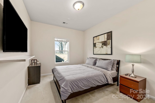 bedroom featuring light carpet