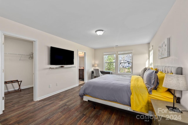 bedroom featuring a spacious closet, a closet, ensuite bathroom, and dark hardwood / wood-style flooring