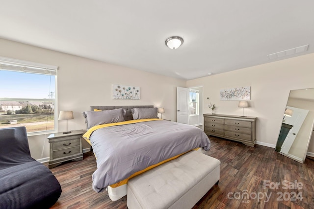 bedroom with dark hardwood / wood-style flooring