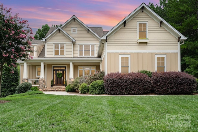 view of front of house with a lawn and a porch