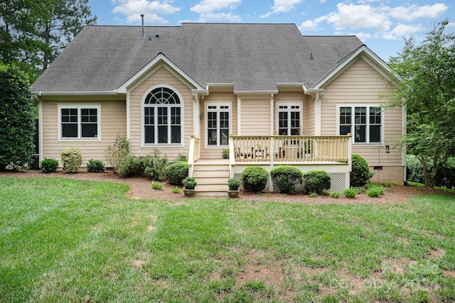 back of property with a lawn and a deck