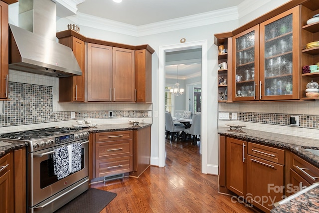 kitchen with wall chimney exhaust hood, high end stainless steel range oven, dark hardwood / wood-style floors, crown molding, and decorative backsplash