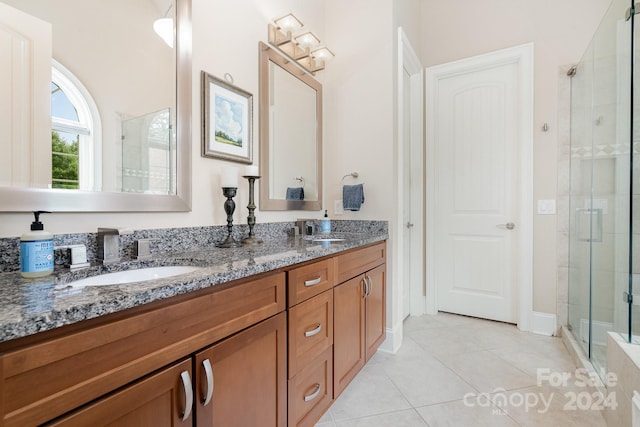 bathroom featuring vanity, an enclosed shower, and tile patterned floors