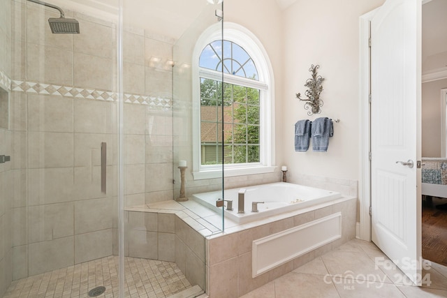 bathroom featuring tile patterned floors and separate shower and tub