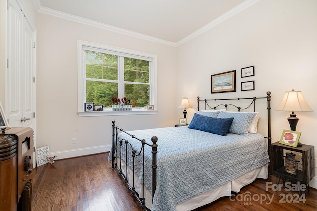 bedroom featuring dark hardwood / wood-style floors and crown molding