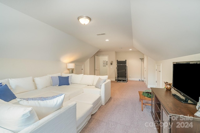 living room with lofted ceiling and light carpet