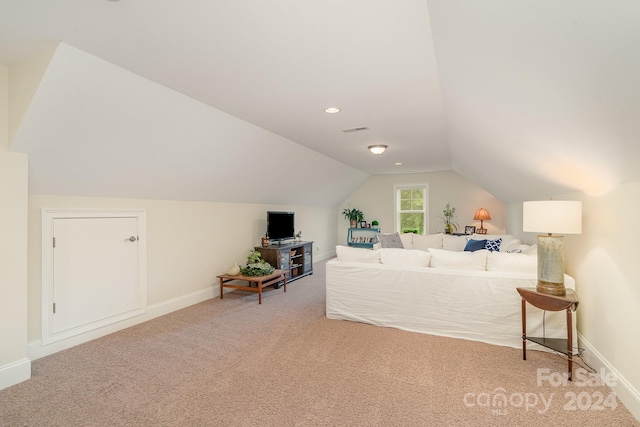 bedroom with vaulted ceiling and carpet flooring