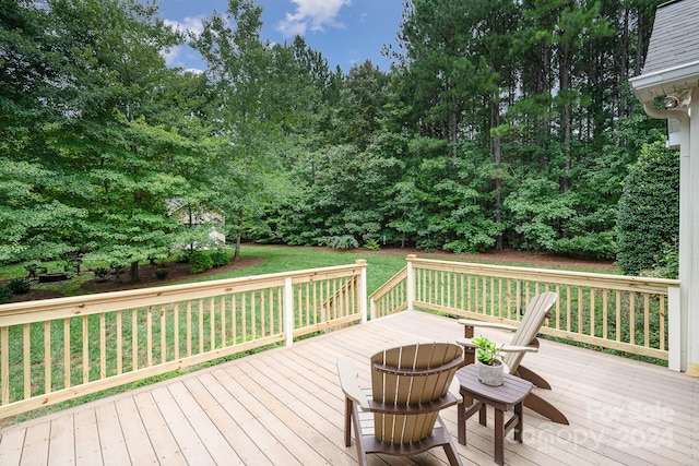 wooden deck featuring a yard