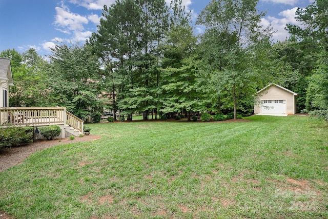 view of yard with an outdoor structure, a garage, and a deck