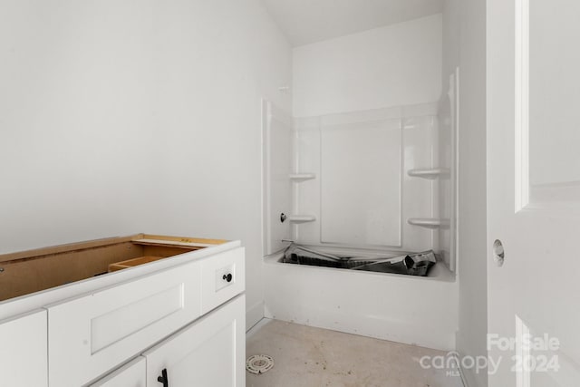 bathroom featuring concrete floors and shower / bath combination