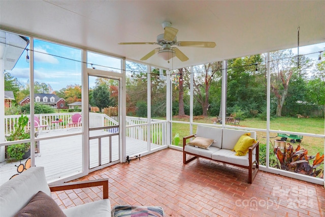 sunroom featuring ceiling fan