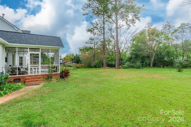 view of yard with a sunroom