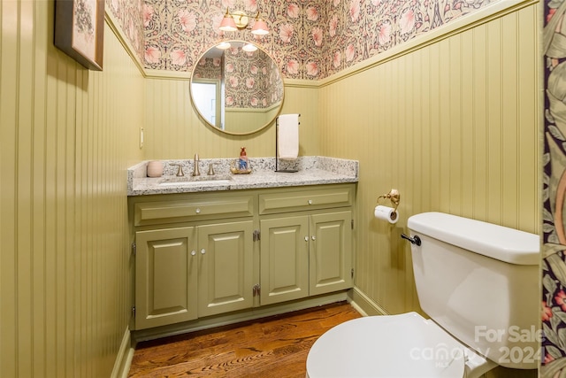 bathroom featuring hardwood / wood-style flooring, vanity, and toilet