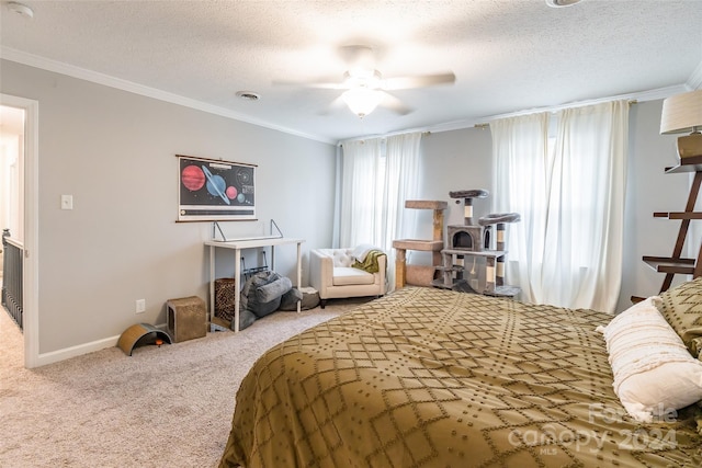 carpeted bedroom featuring a textured ceiling, ceiling fan, and crown molding