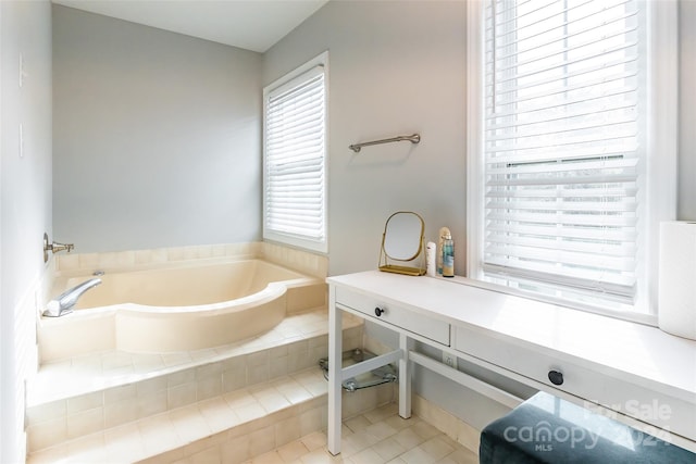 bathroom featuring a relaxing tiled tub and tile patterned flooring