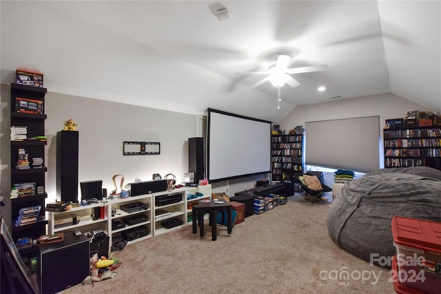 carpeted home theater room with ceiling fan and vaulted ceiling