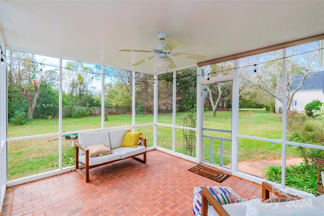 sunroom featuring ceiling fan