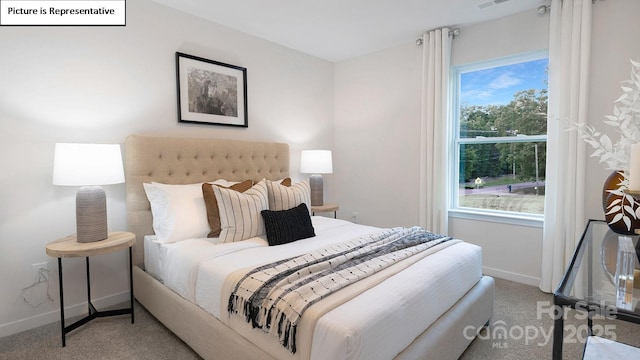 carpeted bedroom with visible vents and baseboards